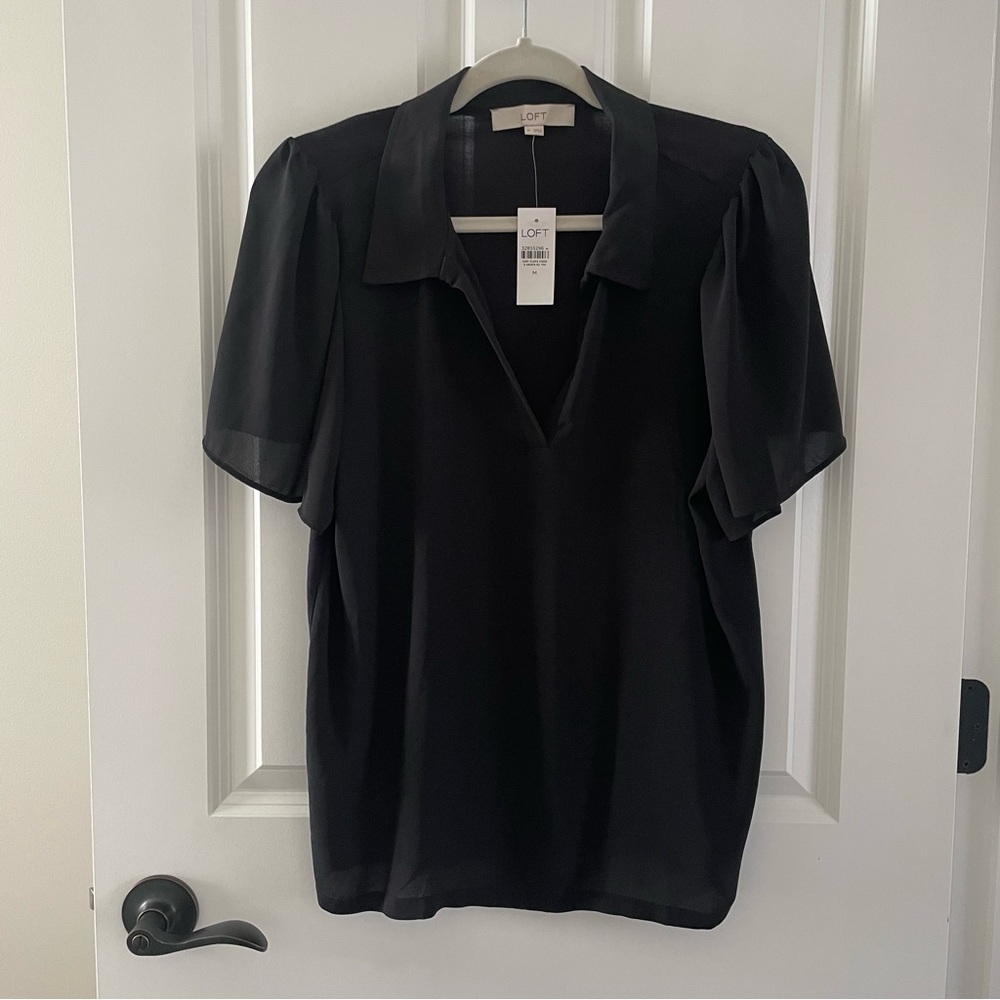 Feminine black top. V-neck with short flowing sleeves. Perfect staple item.